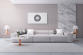 Modern living room with a gray sofa, marble accent wall, minimal decor and a white, black and grey artwork on the wall.